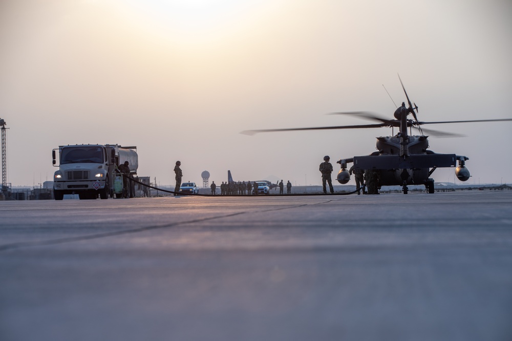 U.S. Army and Air Force Personnel Fuel a UH-60 Black Hawk Helicopter