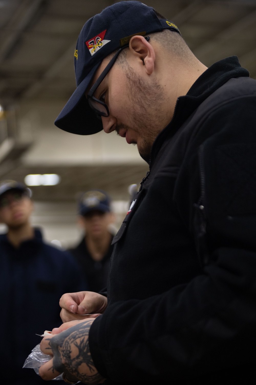 USS Ronald Reagan (CVN 76) Sailors issue personal protective equipment