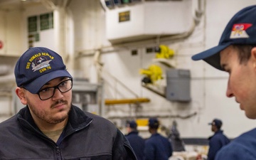 USS Ronald Reagan (CVN 76) Sailors issue personal protective equipment