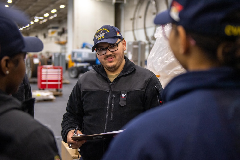 USS Ronald Reagan (CVN 76) Sailors issue personal protective equipment