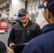 USS Ronald Reagan (CVN 76) Sailors issue personal protective equipment