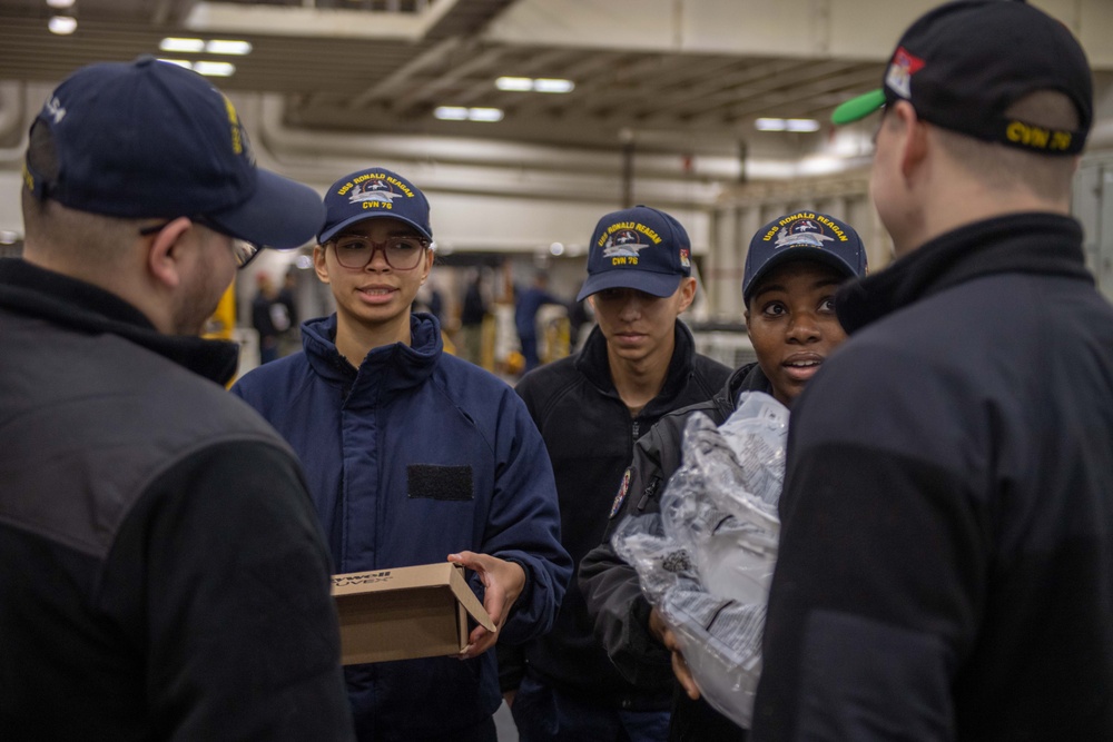 USS Ronald Reagan (CVN 76) Sailors issue personal protective equipment