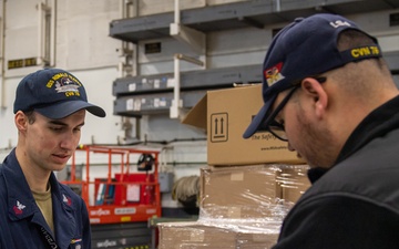 USS Ronald Reagan (CVN 76) Sailors issue personal protective equipment