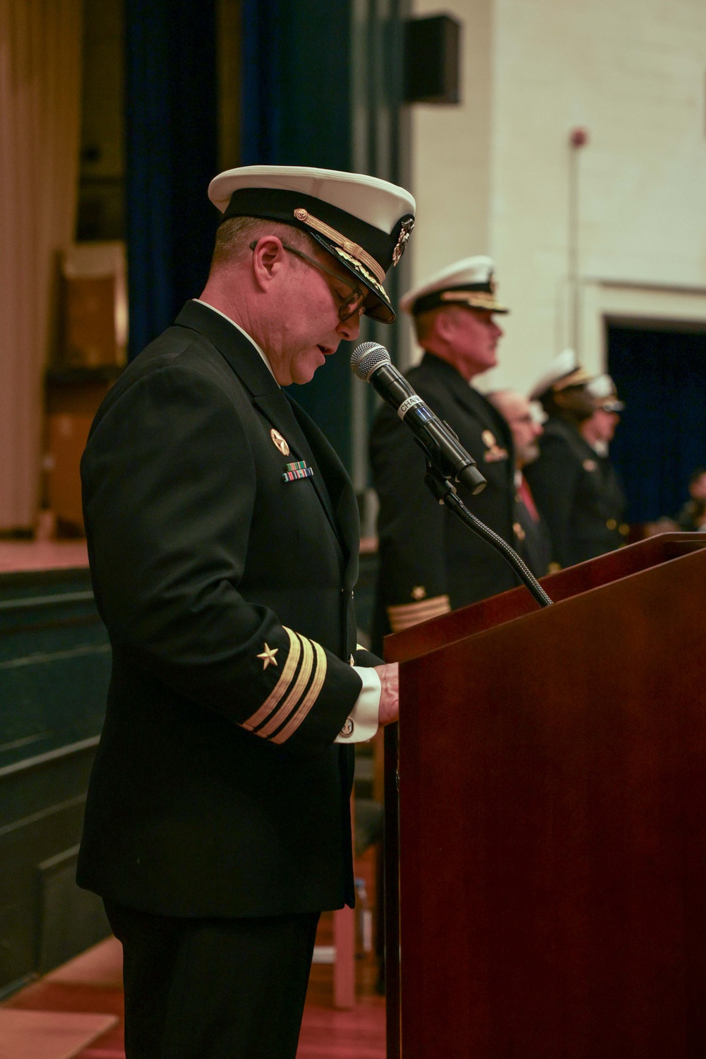 U.S. Navy Cmdr. Chance Smith addresses the crowd during a change of command ceremony for USS Truxtun (DDG 103)