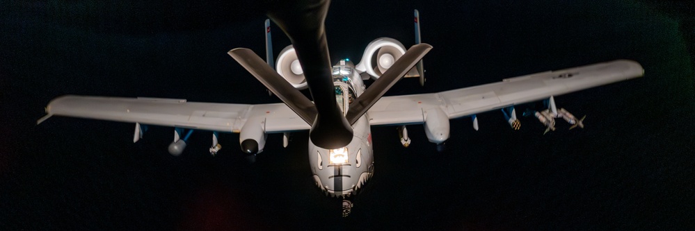 A-10 Thunderbolt II aircraft refuel with KC-135 Stratotanker at night