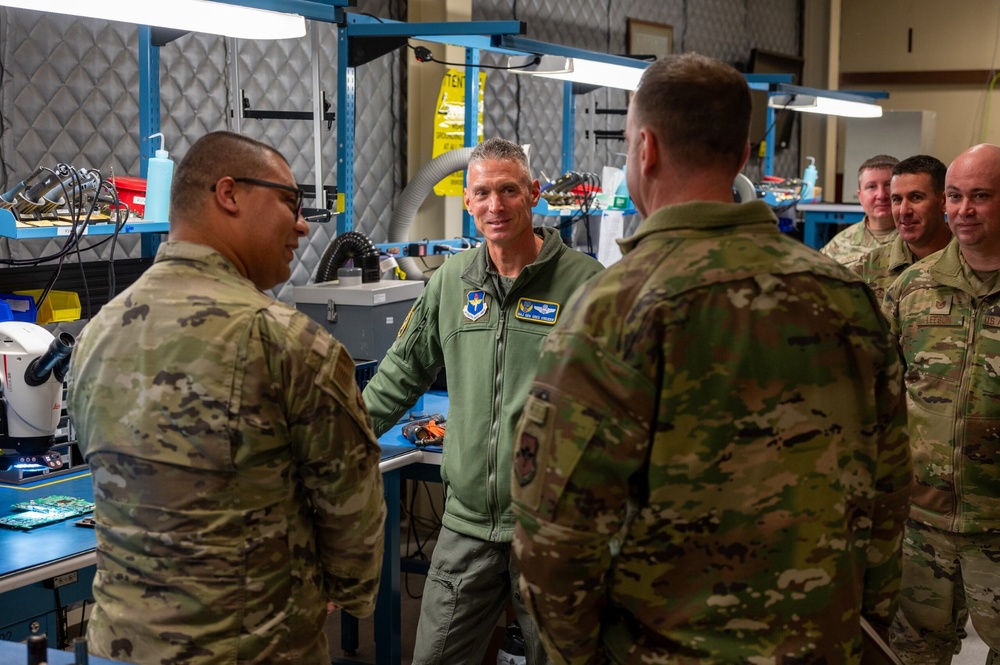 Maj. Gen. Gregory Kreuder, 19th Air Force Commander, tours the electronics repair back-shop in the Human Performance and Leadership Center