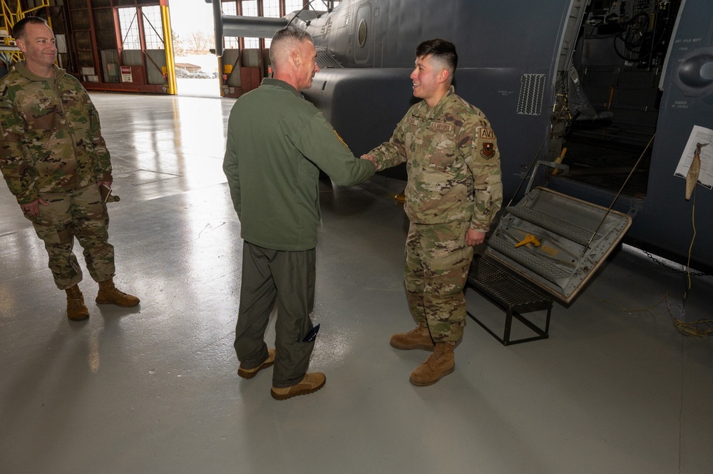 Maj. Gen. Gregory Kreuder, 19th Air Force Commander, coins Airman 1st Class Josue Quezada, 58th Special Operations Wing avionics apprentice, after he received a coin from Maj. Gen. Kreuder