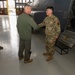 Maj. Gen. Gregory Kreuder, 19th Air Force Commander, coins Airman 1st Class Josue Quezada, 58th Special Operations Wing avionics apprentice, after he received a coin from Maj. Gen. Kreuder