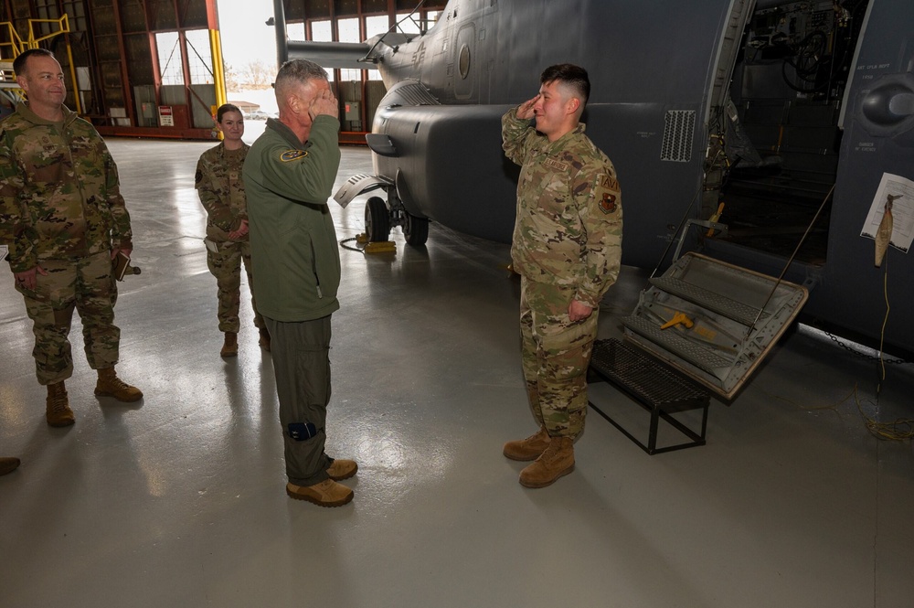 Maj. Gen. Gregory Kreuder, 19th Air Force Commander, is saluted by Airman 1st Class Josue Quezada, 58th Special Operations Wing avionics apprentice, after he received a coin from Maj. Gen. Kreuder