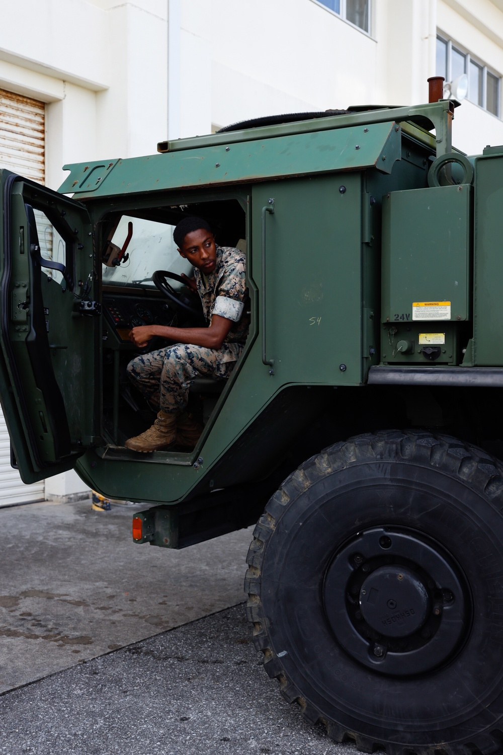 Motor transport operators prepare vehicles for mission