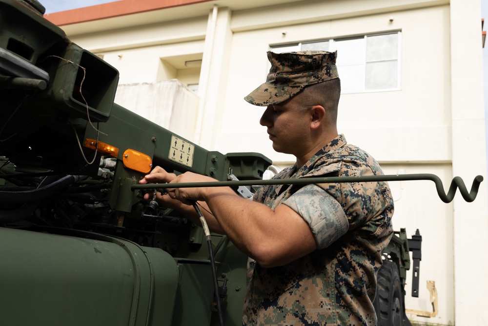 Motor transport operators prepare vehicles for mission