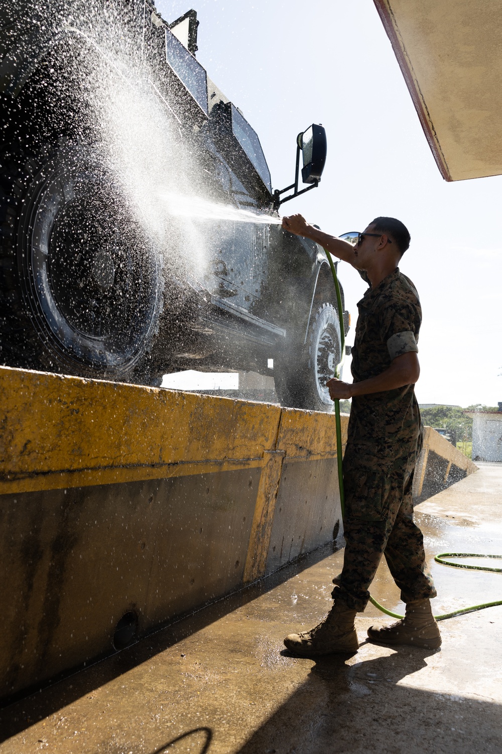 Motor transport operators prepare vehicles for mission