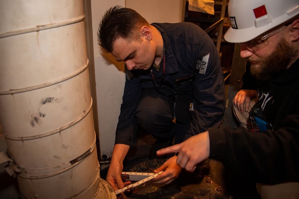 Contractors conduct equipment assessments on the USS Ronald Reagan (CVN 76)