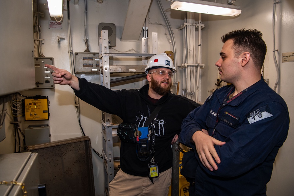 Contractors conduct equipment assessments on the USS Ronald Reagan (CVN 76)