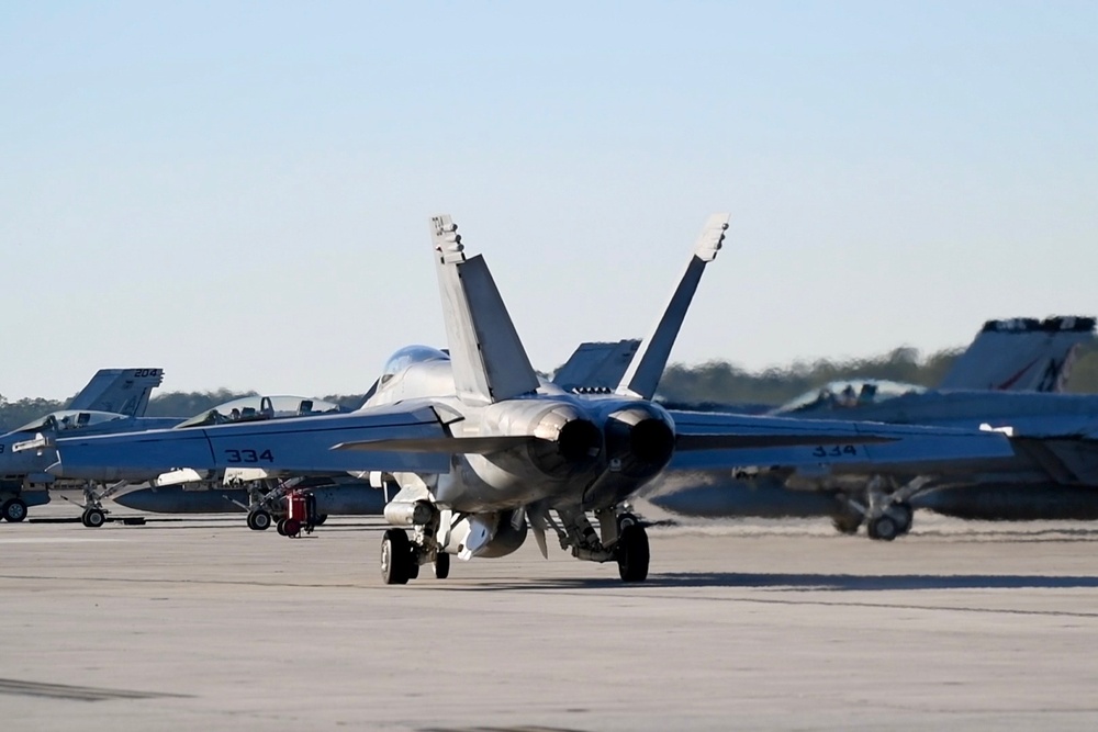 30 F/A-18 Super Hornets from Naval Air Station Oceana staged at Naval Air Station Jacksonville for a flyover honoring former U.S. President Jimmy Carter.