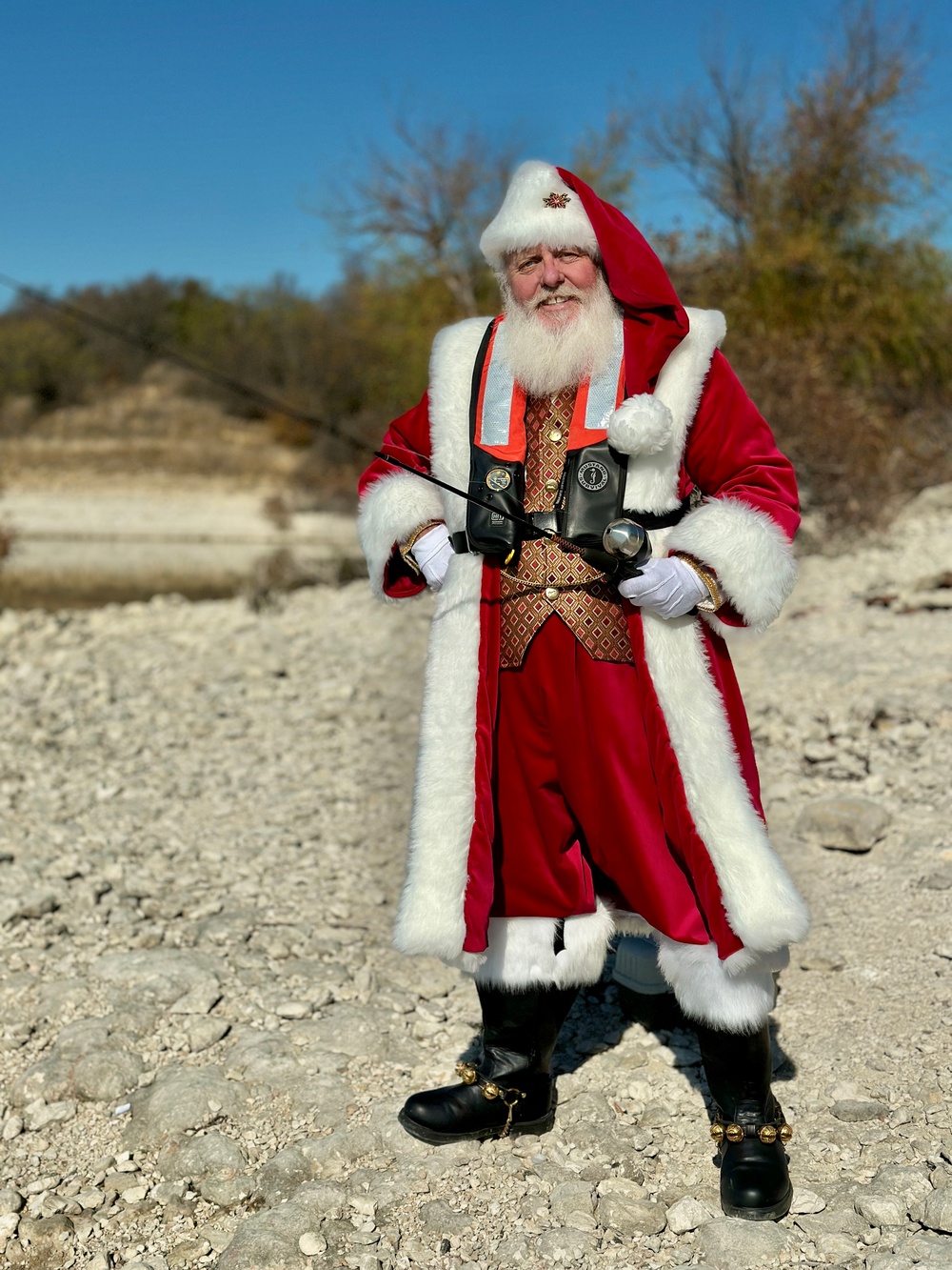 Santa holding fishing pole and wearing life jacket