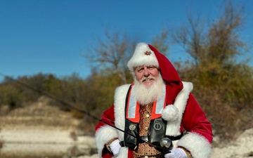 Santa holding fishing pole and wearing life jacket