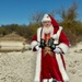 Santa holding fishing pole and wearing life jacket