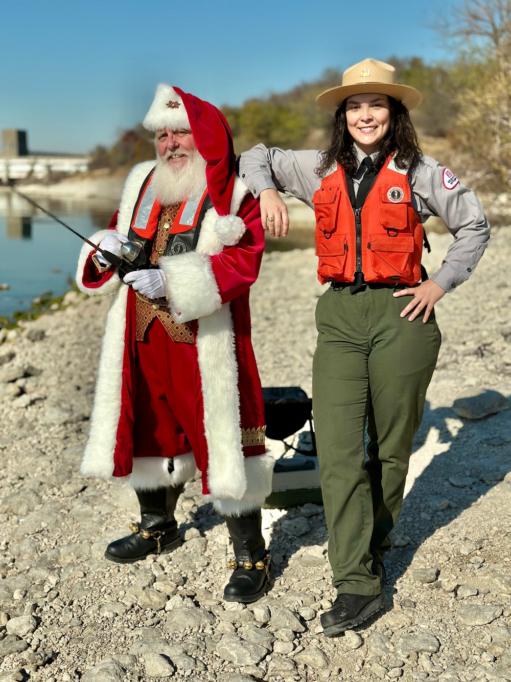 Santa holding fishing pole wearing life jacket with USACE Ranger