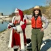 Santa holding fishing pole wearing life jacket with USACE Ranger