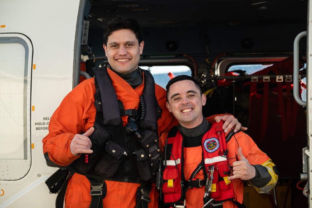 Coast Guard helicopter crew rescues two survivors from capsized vessel