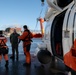 Coast Guard helicopter crew rescues two survivors from capsized vessel