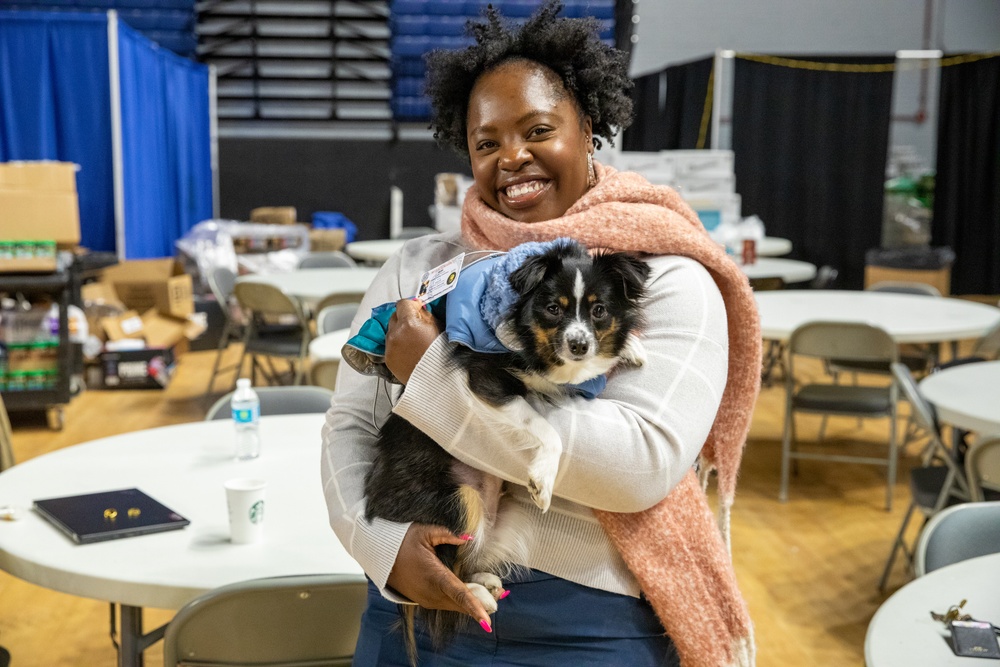 Soldier and Family Readiness Specialist Hawa Bangura Poses with her Emotional Support Dog While Supporting 60th Presidential Inauguration