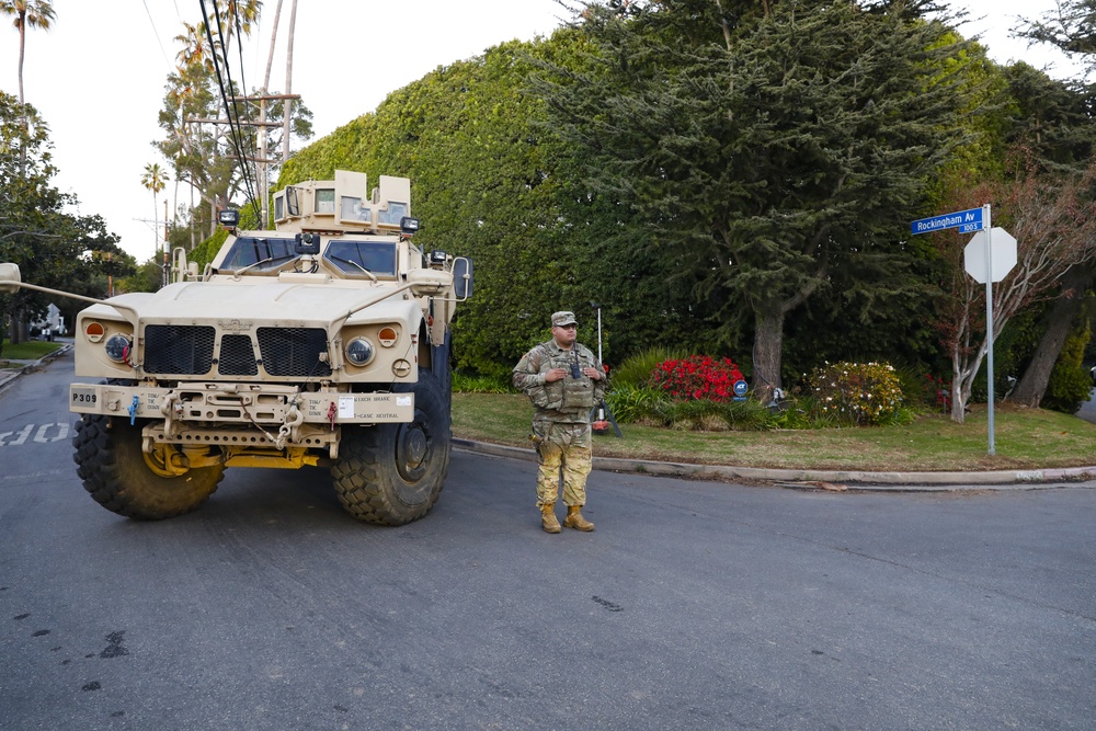 330th and 670th Military Police Companies stand watch as the sun sets in LA