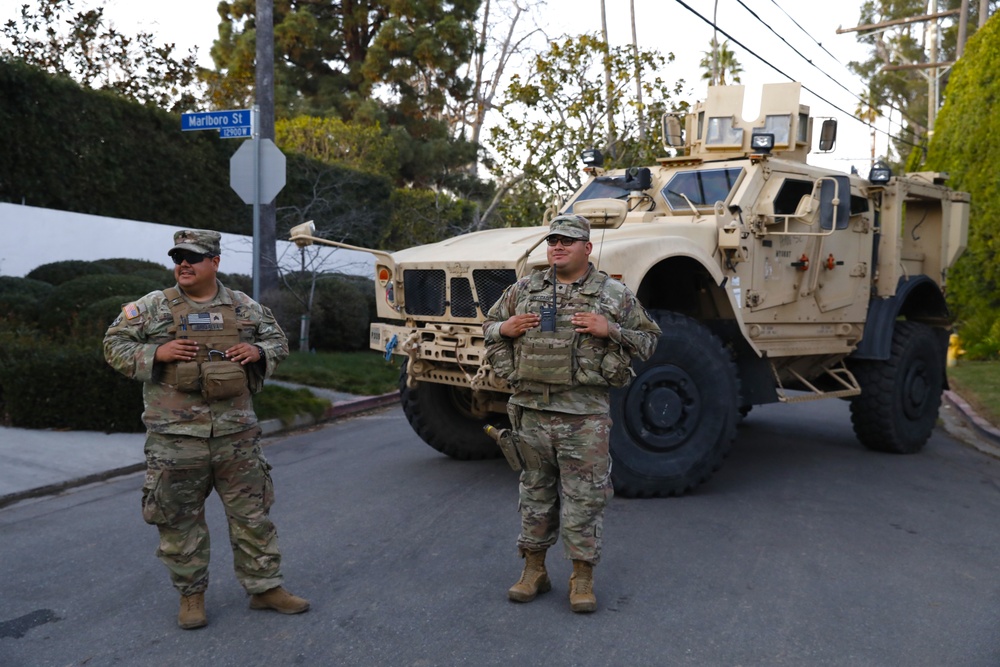 Cal Guard's 330th and 670th Military Police stand watch as the sun sets in LA