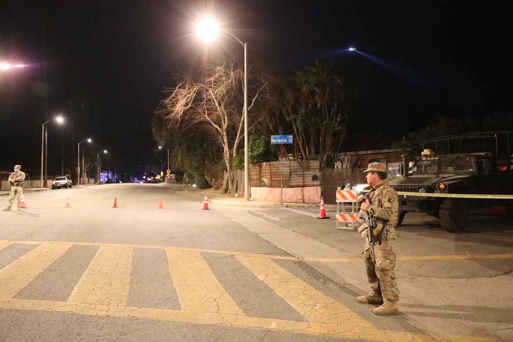 1st Battalion, 143rd Field Artillery Regiment Soldiers guard TCPs with local law enforcement