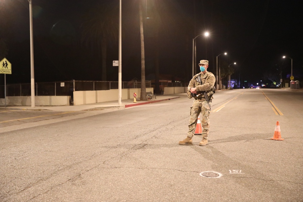 1st Battalion, 143rd Field Artillery Regiment Soldiers guard TCPs with local law enforcement