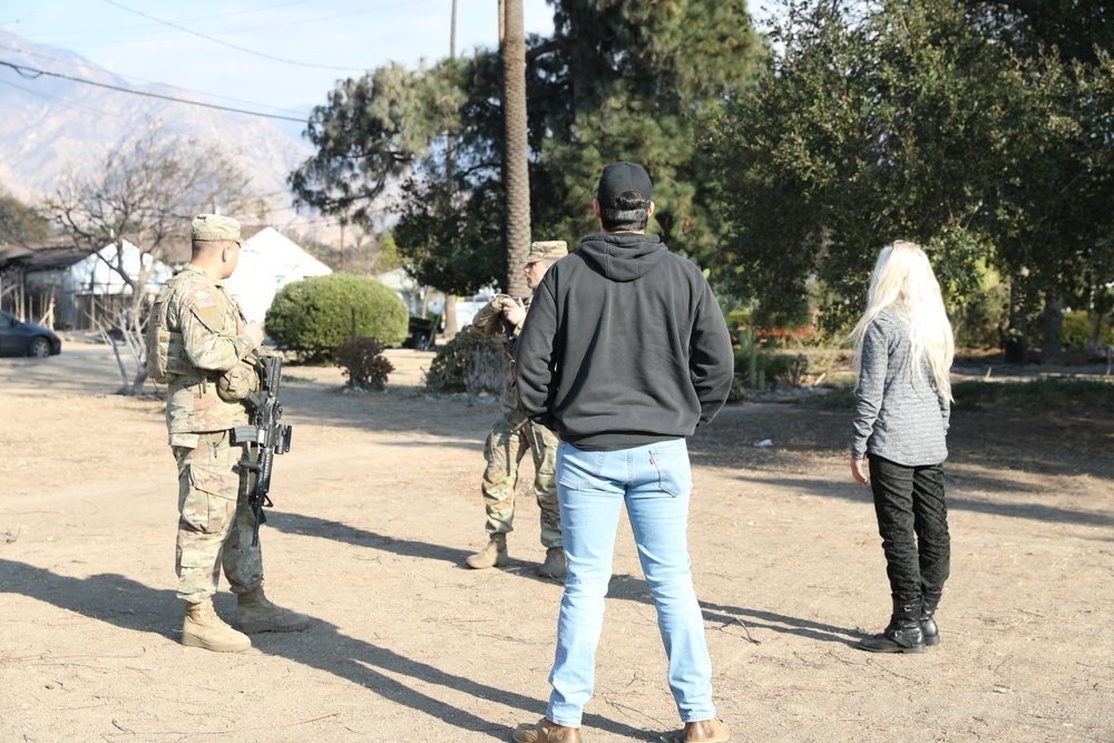 1st Battalion, 143rd Field Artillery Regiment Soldiers guard TCPs with local law enforcement