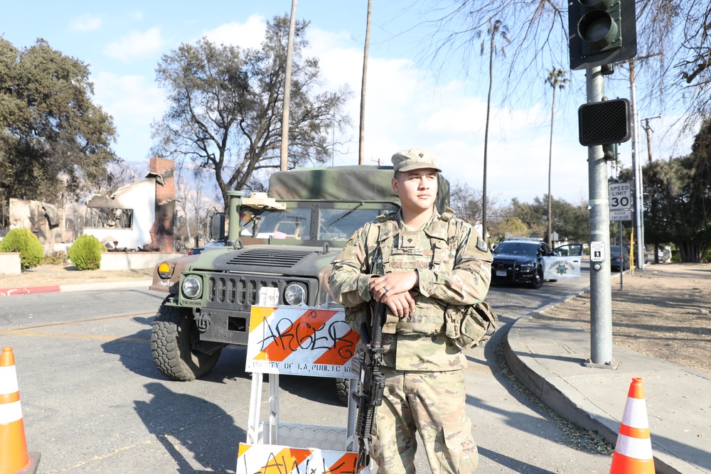 1st Battalion, 143rd Field Artillery Regiment Soldiers guard TCPs with local law enforcement