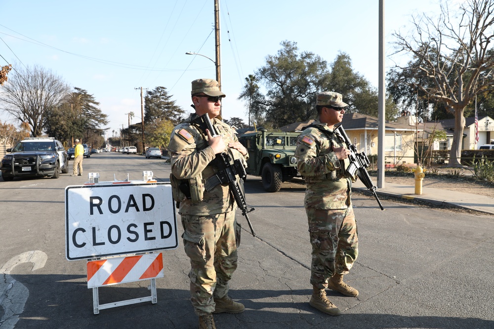 1st Battalion, 143rd Field Artillery Regiment Soldiers guard TCPs with local law enforcement