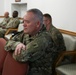 Service Member Kneel in Prayer During Religious Services