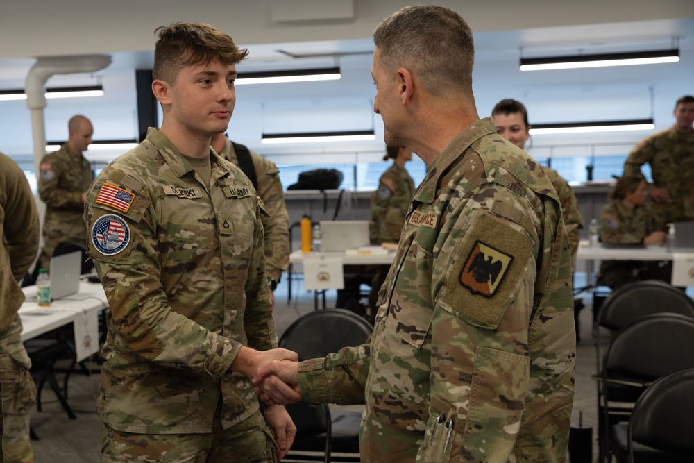 U.S. Army Pfc. Perry Solinski Receives a Challenge Coin from Chief of the National Guard Bureau, Gen. Steven Nordhaus