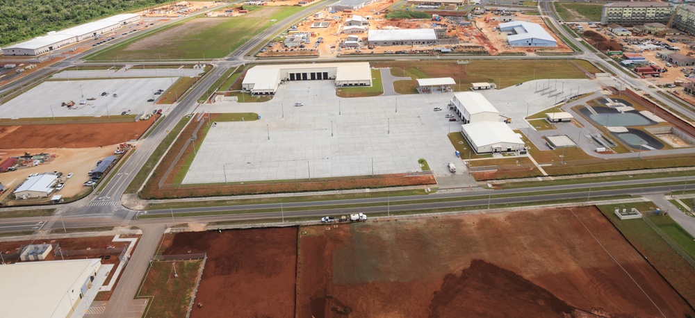 An Aerial View of a Nearly Finished Vehicle Maintenance Shop on Marine Corps Camp Blaz, Surrounded by Ongoing Construction