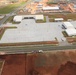 An Aerial View of a Nearly Finished Vehicle Maintenance Shop on Marine Corps Camp Blaz, Surrounded by Ongoing Construction