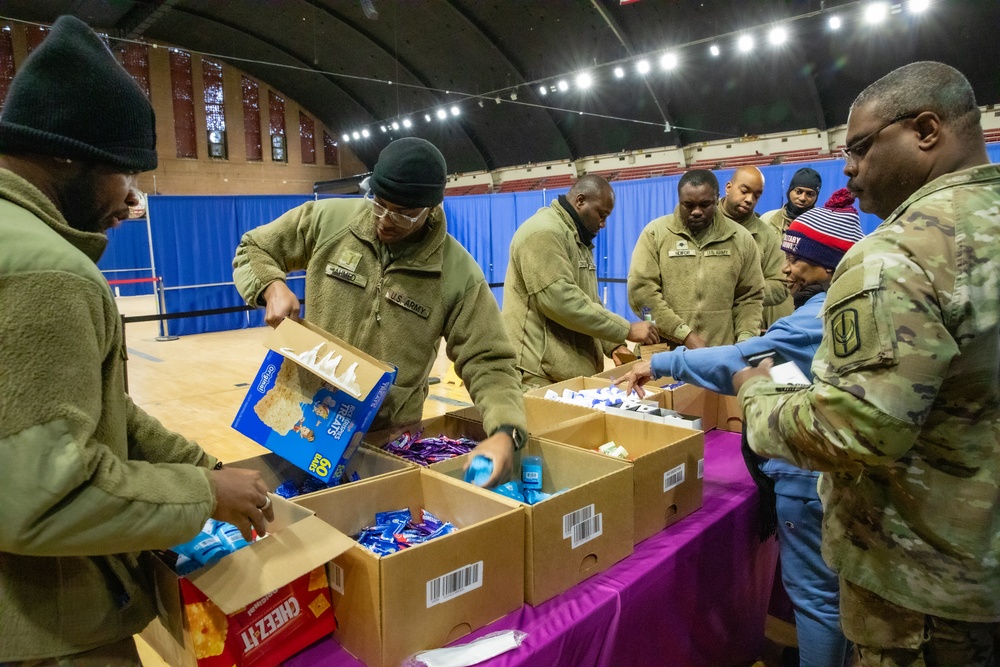 U.S. Army National Guard Soldiers assigned to Joint Task Force - District of Columbia Receive Snacks and Toiletries from the Family Readiness Team at the D.C. Armory