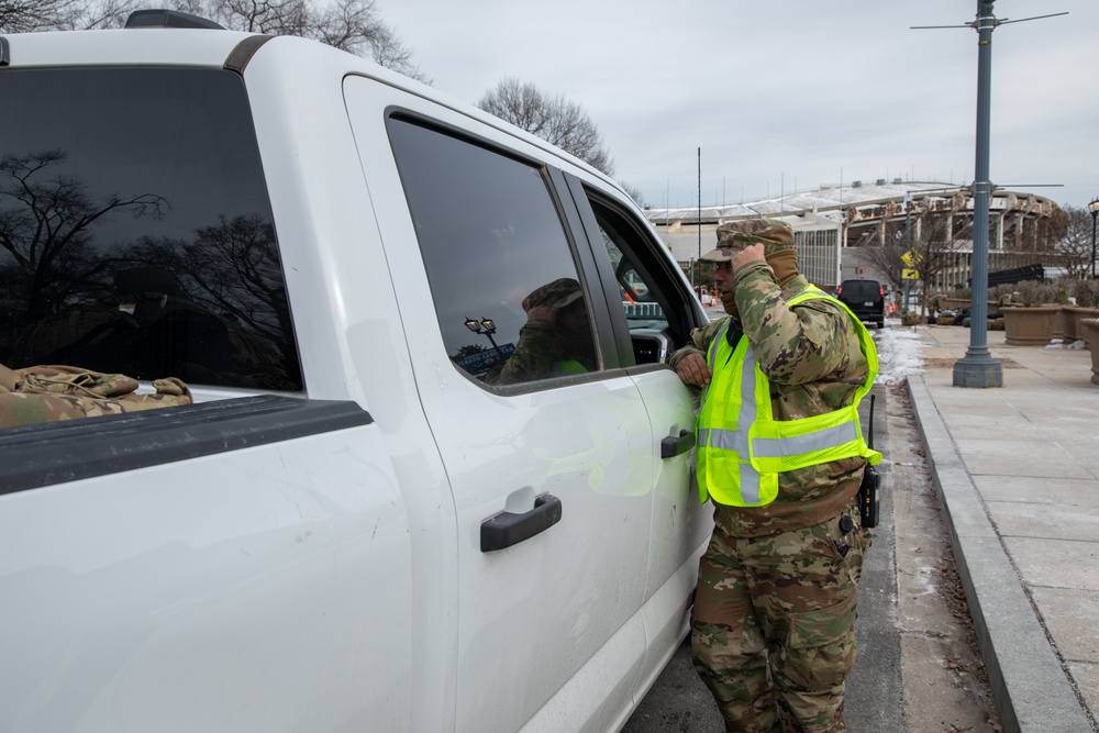 U.S. Army Staff Sgt. Anthony Cintron Directs a Vehicle at the D.C. Armory