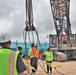 A Safety Specialist with OICC MCM Advises Construction Workers as they Prepare for a Crane Load Test