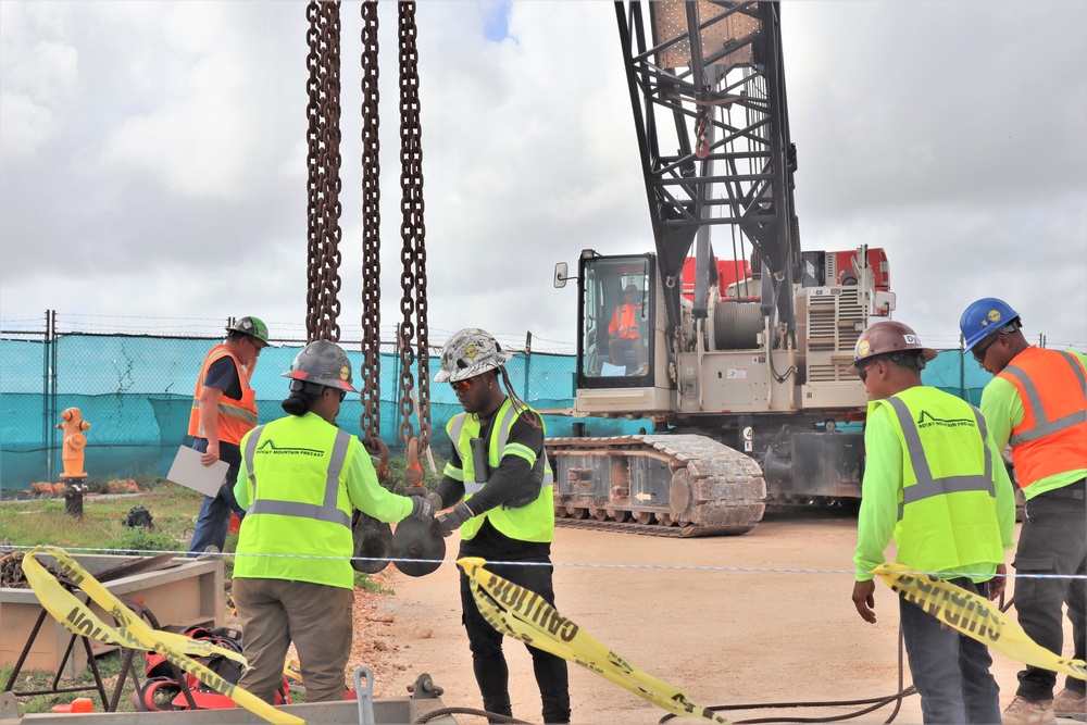 Crew Members Double-Check Coupling Components During a Crane Load Test