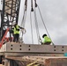 Crew Members Prep Guide Ropes and Grapples During a Concrete Load Test