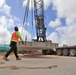 A Spotter Moves Out of the Way of a Ten-Ton Precast Concrete Slab During a Crane Load Test