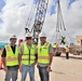 A Contractor Poses with OICC MCM Safety Specialists After a Successful Crane Load Test