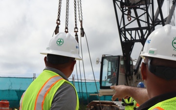 Safety Specialists with the Office in Charge of Construction Monitor for Safety Concerns During a Crane Load Test