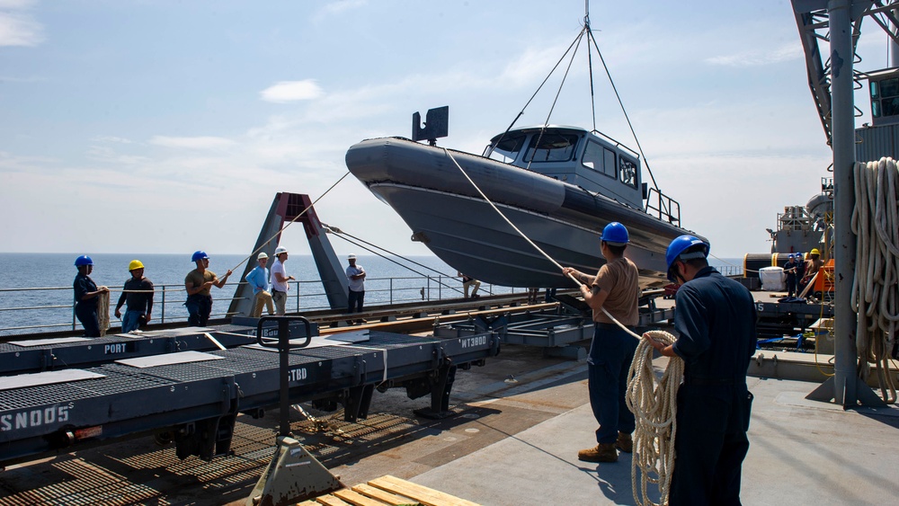 Emory S. Land conducts (AS 39) boat operations while anchored in the Andaman Sea