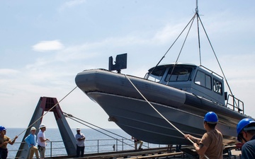 Emory S. Land conducts (AS 39) boat operations while anchored in the Andaman Sea