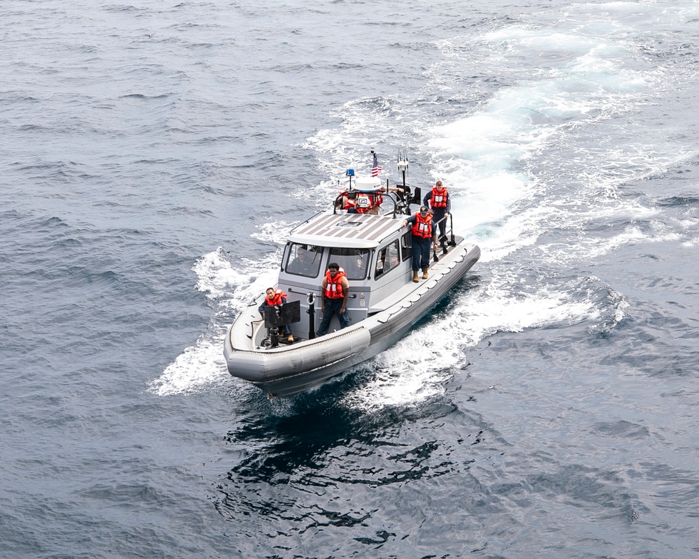 Emory S. Land conducts boat operations while anchored in Andaman Sea