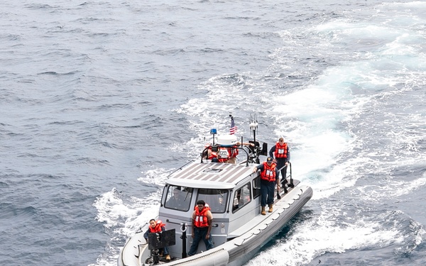 Emory S. Land conducts boat operations while anchored in Andaman Sea